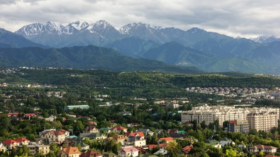 Almaty ai piedi del Tian Shan — I tetti rossi della città che si arrampicano verso le vette innevate