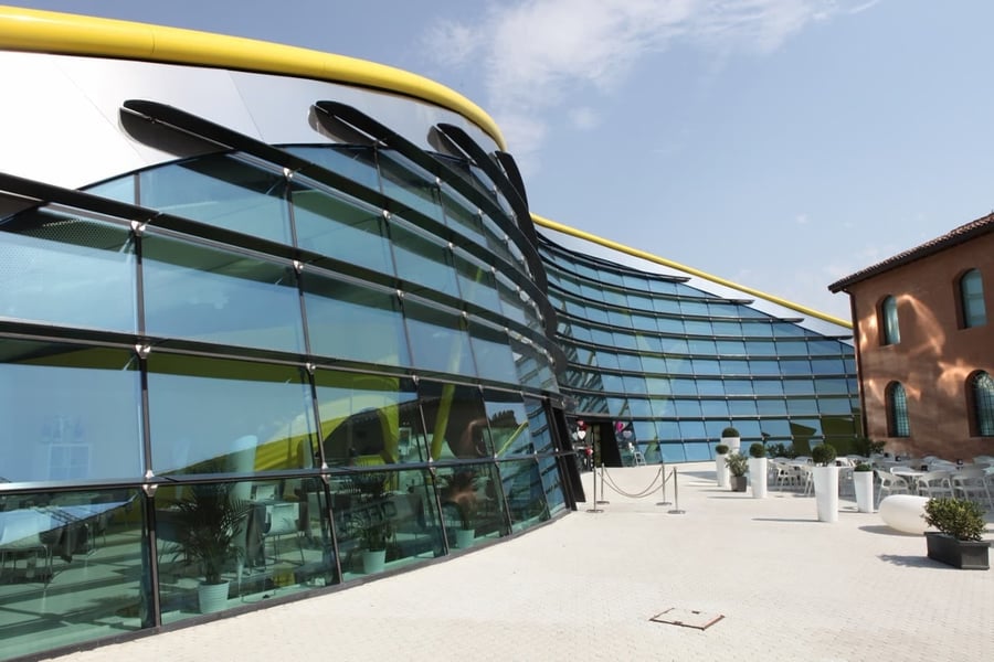 Museo Casa Enzo Ferrari — A yellow bonnet of metal and glass rises beside the workshop where it all began