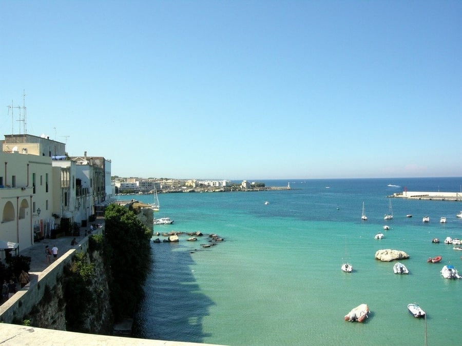 Otranto's harbour — Boats and white houses on the Strait of Otranto