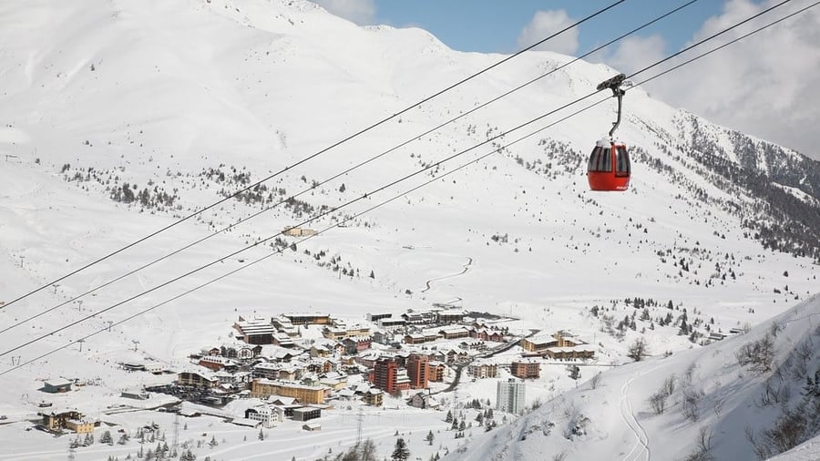 Tonale Pass — The cable car climbing among the ski slopes