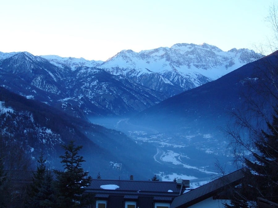 The Susa Valley at dusk — Evening haze settling over the snowy valley floor