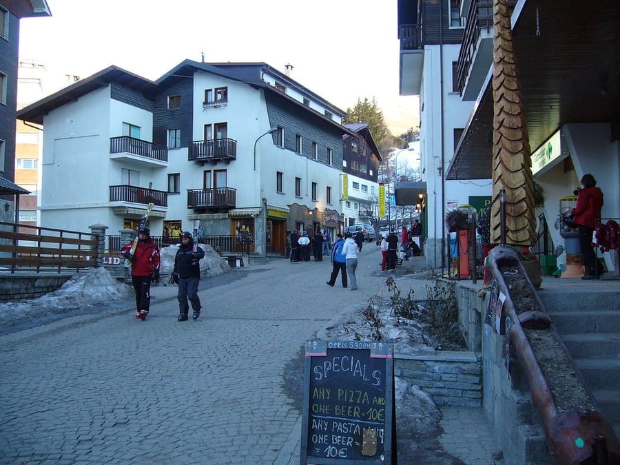 The town's streets in winter — Skiers strolling among the shops at night